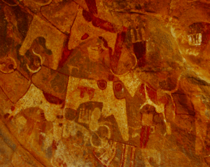 Laas Geel Caves, Dhagah Gure Ancient Rock Art, and Hargeisa City Tour This image shows ancient rock art, possibly depicting animals and human figures in a reddish-brown hue, painted on a rough, textured surface.