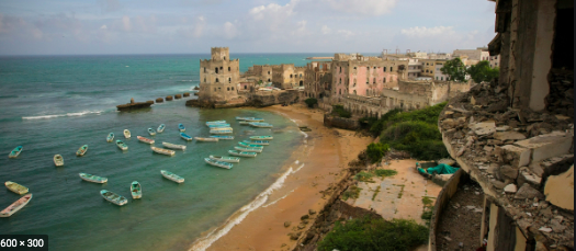 A coastal scene shows turquoise waters dotted with small boats near a weathered town with a castle, juxtaposed with a crumbling building in the foreground.