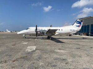Custom Car Rental and Carpool, Domestic Flights, Cooks and Staff and Courses or Housing in Somaliland (Hargeisa) A white turboprop aircraft with "Freedom Airline" and registration number 60-FAV sits on a tarmac under a blue sky.